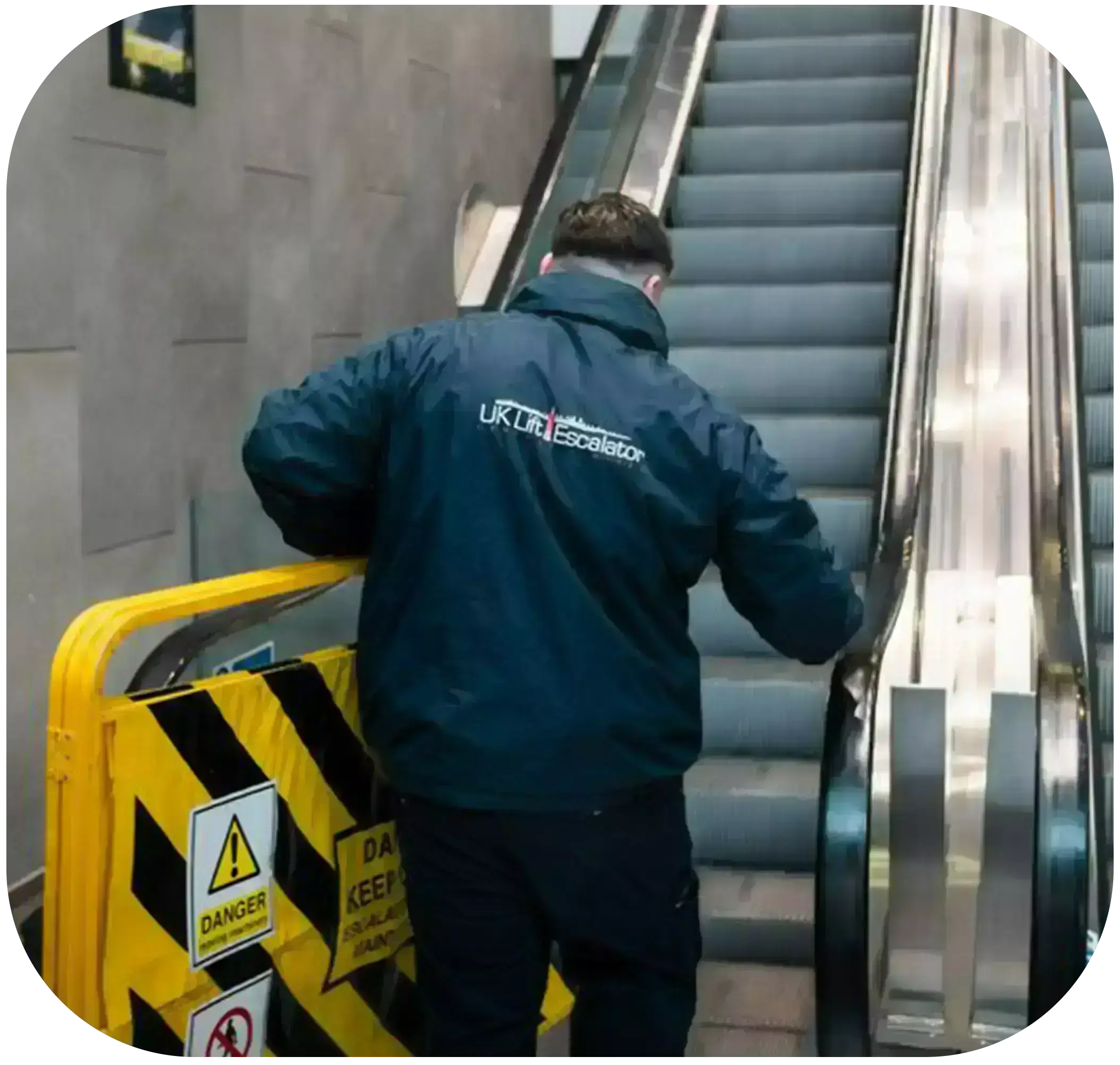A picture of a man in a blue jacket paired with black pants walking towards the escalator to examine it.