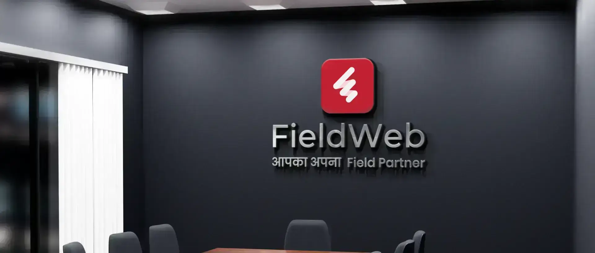 The FieldWeb logo features a red emblem with a white center, in gray text on a charcoal black background  also includes Hindi words, with a modern aesthetic.